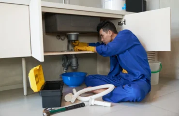 Man fixing a clogged drain